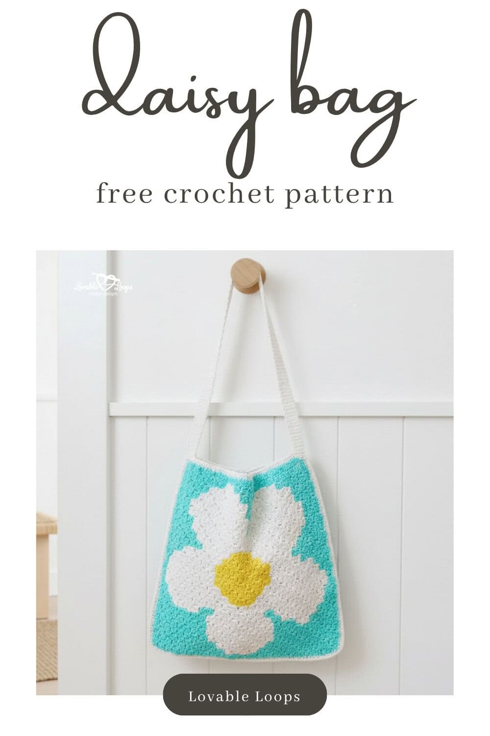 Pinterest pin for a free crochet daisy bag pattern featuring an aqua tote with a large white daisy and yellow center hanging on a white paneled wall.