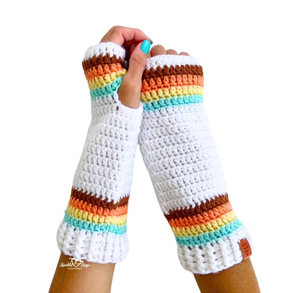 Front view of two colorful crochet arm warmers with ribbed cuffs and rainbow-inspired stripes. Free crochet pattern for beginners.