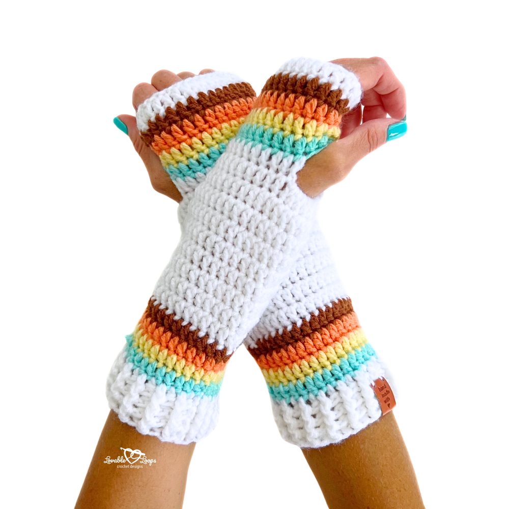 Close-up of colorful crochet arm warmers with retro stripes in white, brown, orange, yellow, and mint. Beginner-friendly fingerless gloves pattern.