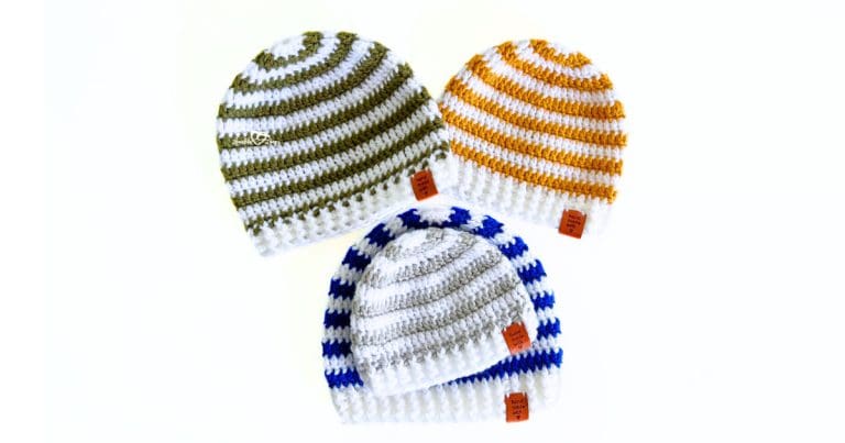 Four striped crochet beanie hats in olive green, mustard yellow, royal blue, and gray, arranged in a playful layout, each with a ribbed brim and “handmade with love” tag, made using a free beginner-friendly beanie pattern for all sizes.