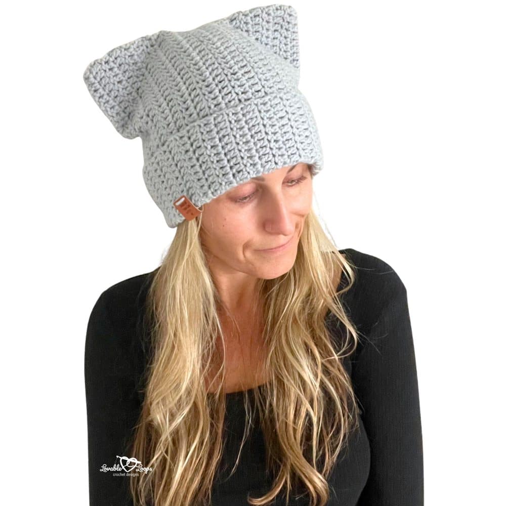 Woman wearing a handmade gray crochet cat beanie with cat ears. Beginner-friendly crochet cat hat pattern that’s quick and easy to make.