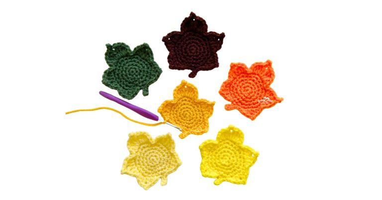 Crochet maple leaf appliques in fall colors arranged with a purple crochet hook and yellow yarn. Free and beginner-friendly maple leaf crochet pattern.