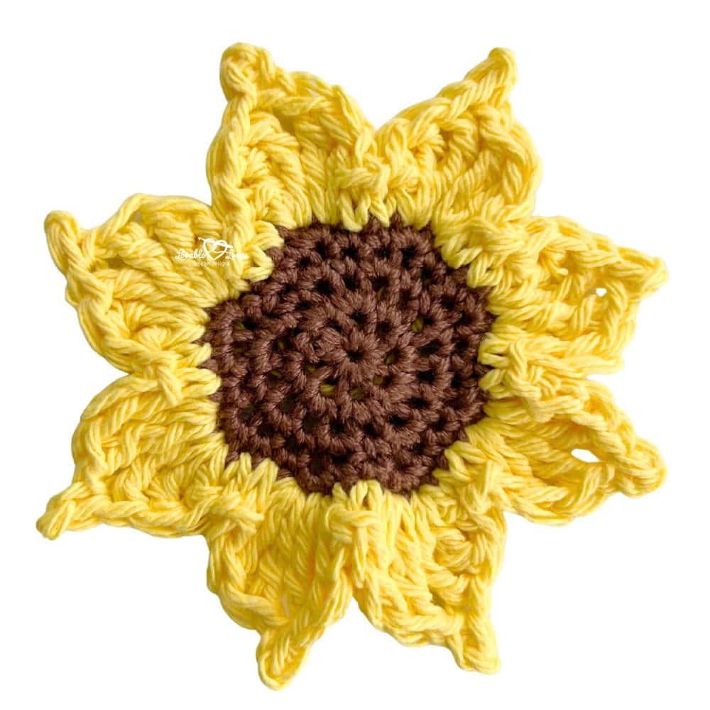 Yellow and brown crochet sunflower applique shown on a white background. Free crochet sunflower pattern for beginners and easy crochet flower motif.