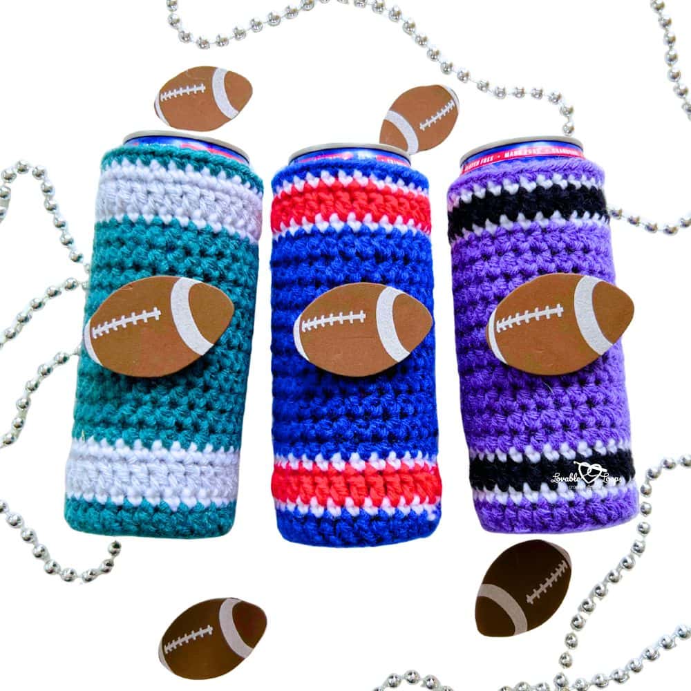 Three slim crochet can cozies in teal, red, white, blue, purple, and black team colors, each decorated with foam football stickers. Fun crochet slim can cozy pattern for football fans and game day parties.