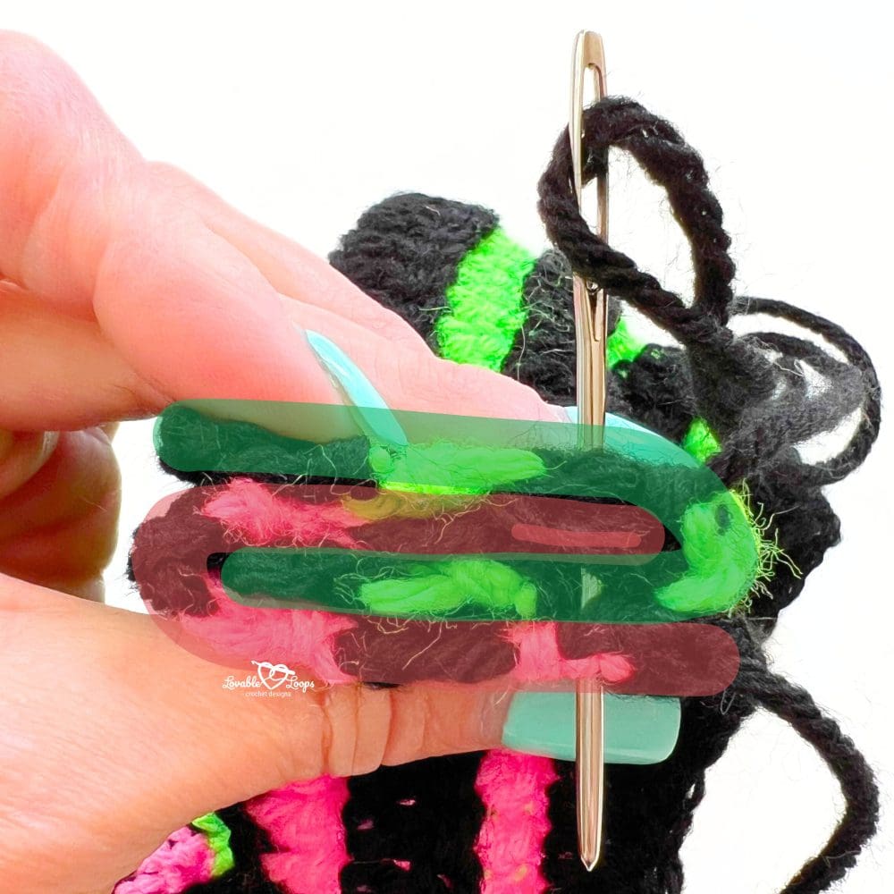 Step-by-step tutorial photo showing how to seam a crochet twisted headband using a yarn needle and striped black, pink, and green yarn.