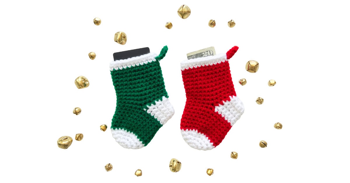 Red and green crochet mini stockings with white trim, filled with money and a gift card. A festive Christmas crochet pattern for ornaments and handmade gifts.