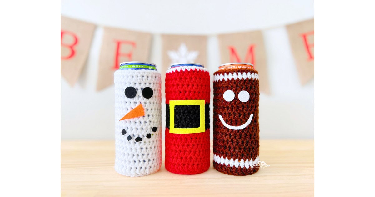 Handmade Christmas crochet cozy pattern featuring three festive designs: a Santa crochet cozy pattern with a yellow belt buckle, a Snowman crochet cozy pattern with a carrot nose and black felt eyes, and a Gingerbread man crochet cozy pattern with a white smile. Perfect holiday crochet cozy pattern for slim cans, gifts, parties, or craft fairs.