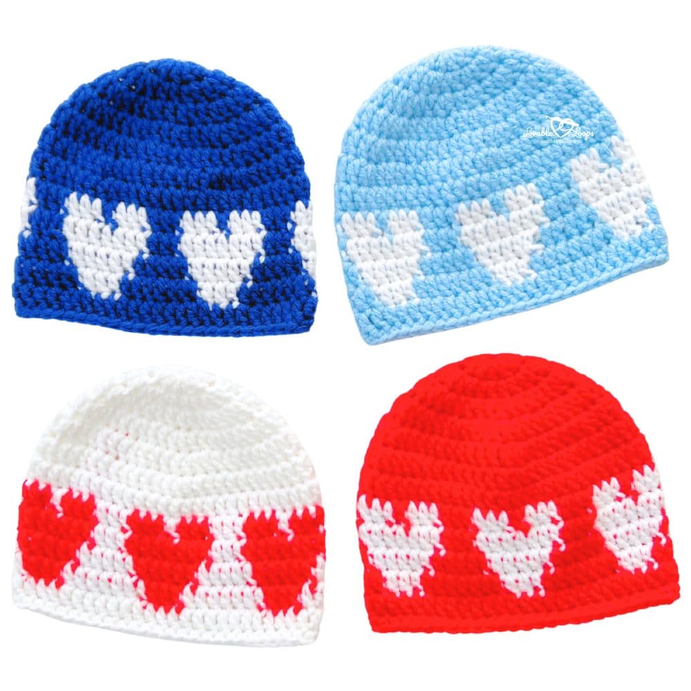 Four crochet baby hats with a round of pixel hearts—royal blue, light blue, red with white hearts, and white with red hearts—on a white background. Beginner-friendly crochet baby hat pattern and crochet heart hat pattern for 6–12 months; great Valentine photo prop.