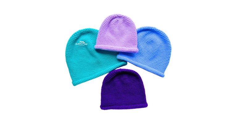 Four single crochet beanies in baby, toddler, child, and adult sizes made in teal, lavender, blue, and purple yarn, showing the simple rolled brim design from a free single crochet beanie pattern on a white background.