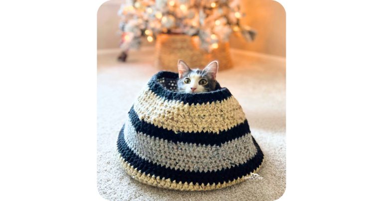 Cozy crochet cat basket with a kitten peeking out, featuring a free crochet cat basket pattern that creates a sturdy, enclosed cat hideaway using super bulky yarn.