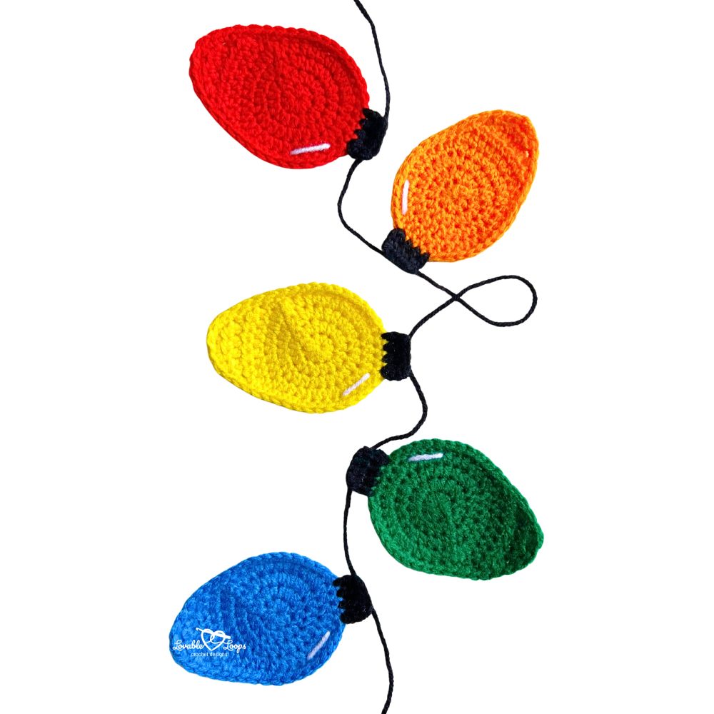 Vertical strand of colorful crochet Christmas lights appliques in red, orange, yellow, green, and blue, made using a free crochet Christmas lights applique pattern.