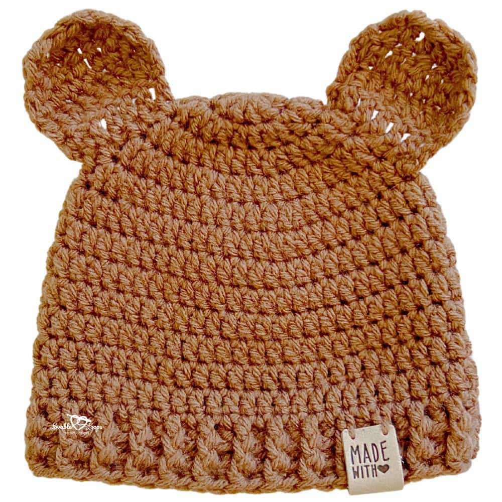 Close-up of a brown crochet baby hat with bear ears made using a baby bear hat crochet pattern, showing double crochet texture and ribbed brim detail.