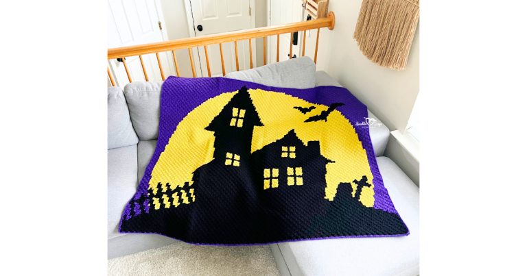 C2C haunted house blanket crochet pattern displayed on a couch with a purple border and yellow moon background