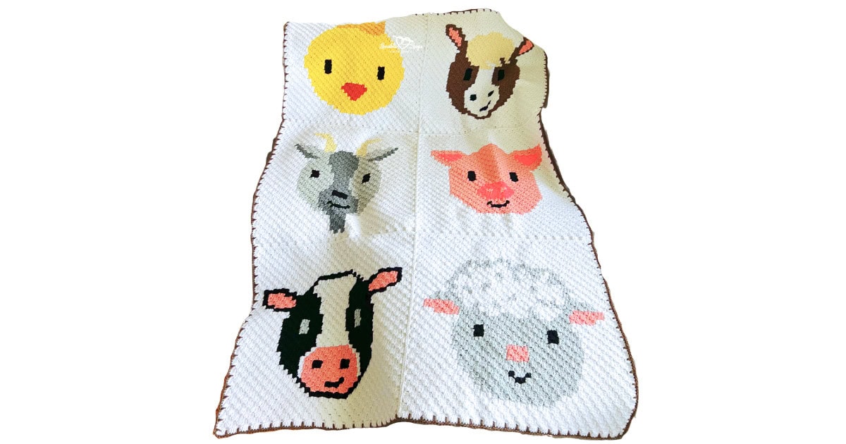 Full view of a C2C crochet farm animal baby blanket featuring six barnyard animal panels: chick, horse, goat, pig, cow, and sheep on a white background with a brown border.