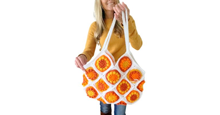 Handmade crochet granny square tote bag made from colorful flower squares with white straps, modern spring-style crochet bag