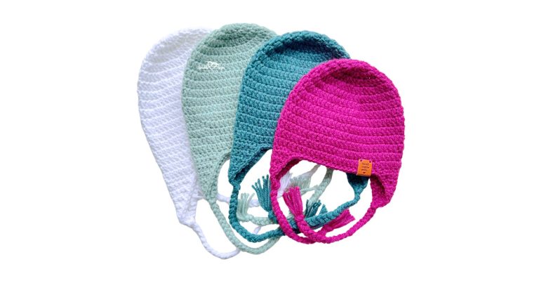 Crochet hat with ear flaps shown in multiple sizes and colors, featuring braided ties and a classic winter earflap design