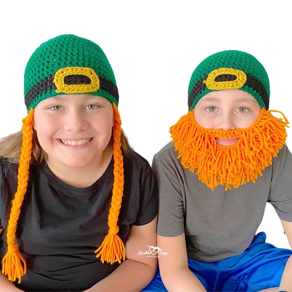 Two kids modeling crochet leprechaun beard hat pattern, one with orange yarn beard and one with braided lass style for St. Patrick’s Day