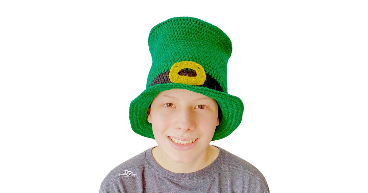 Front view of a handmade crochet leprechaun top hat with structured brim and buckle detail, sized for toddler, child, and adult.
