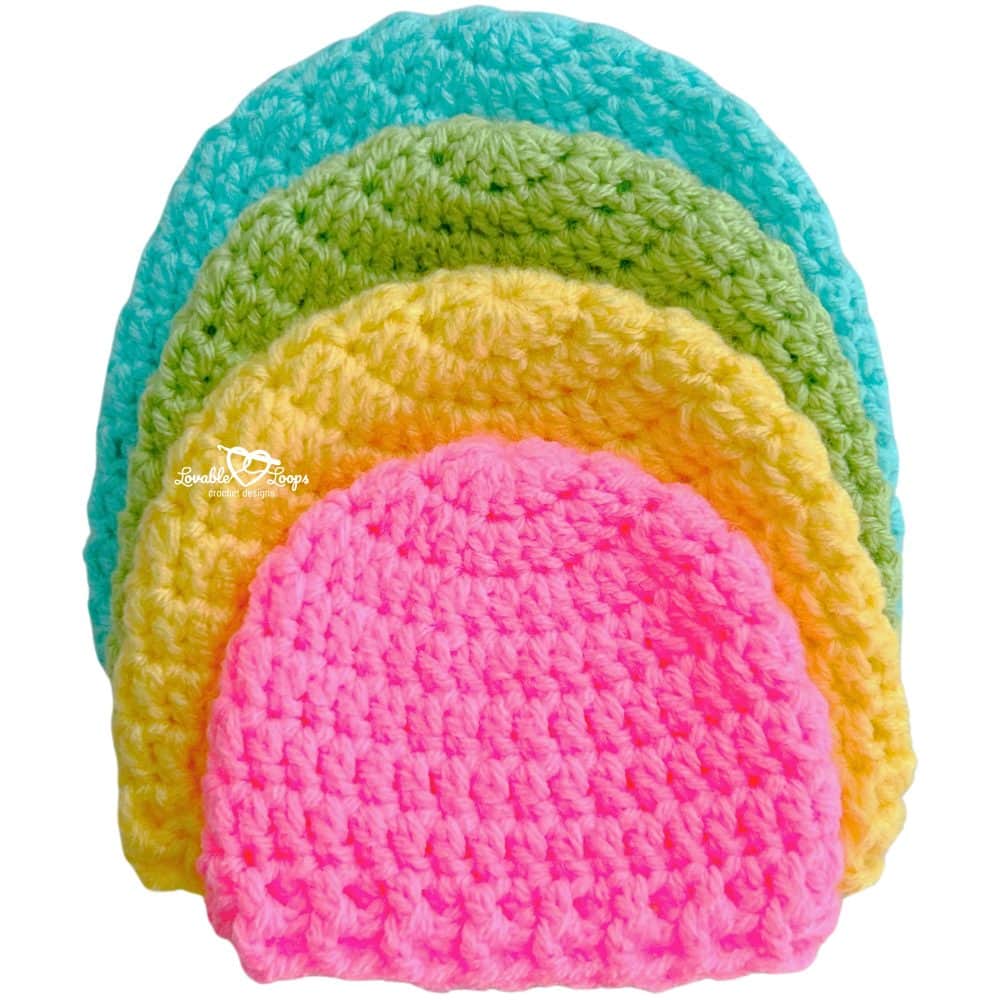 Four crochet newborn hats in pink, yellow, green, and turquoise stacked neatly. Easy and free crochet newborn hat pattern with sizes from preemie to 12 months.