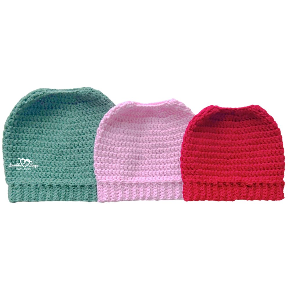 Crochet ponytail hat pattern photo showing three hats side by side in green, pink, and red with a stretchy ribbed brim