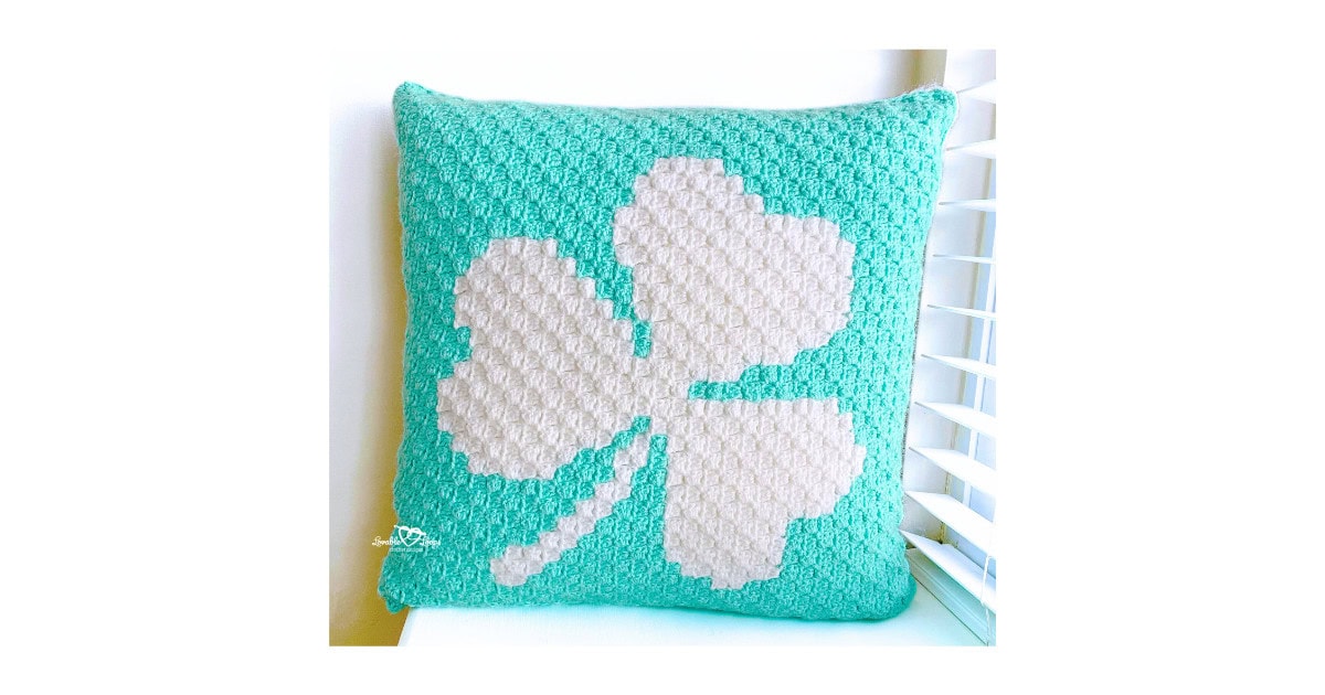 Square C2C crochet shamrock pillow cover in mint green and white, measuring 19 inches, perfect for St. Patrick&rsquo;s Day home decor.