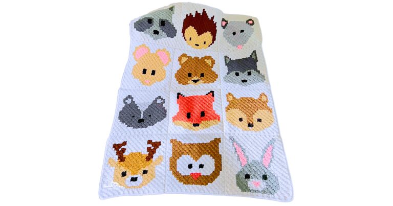 C2C crochet woodland baby blanket featuring 12 separate forest animal panels sewn together, including fox, bear, owl, deer, bunny, raccoon, hedgehog, and wolf.