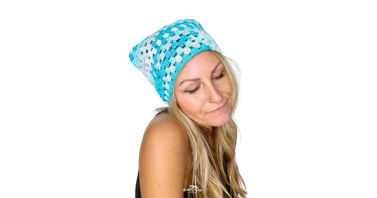 Model wearing a blue handmade crochet bandana accessory featuring a simple granny stitch texture