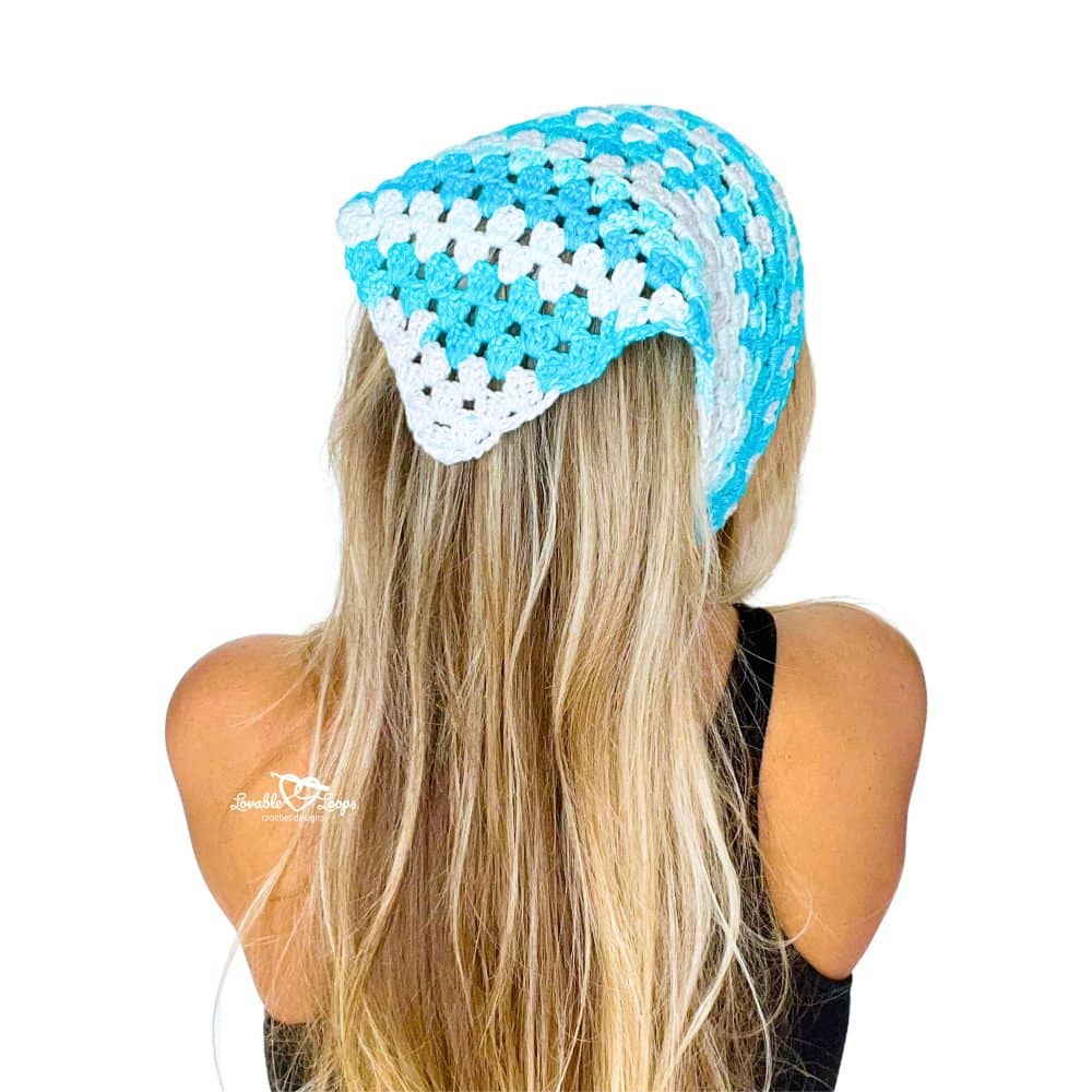 Back view of a woman modeling a free crochet bandana pattern worked in a triangle shape with the granny stitch
