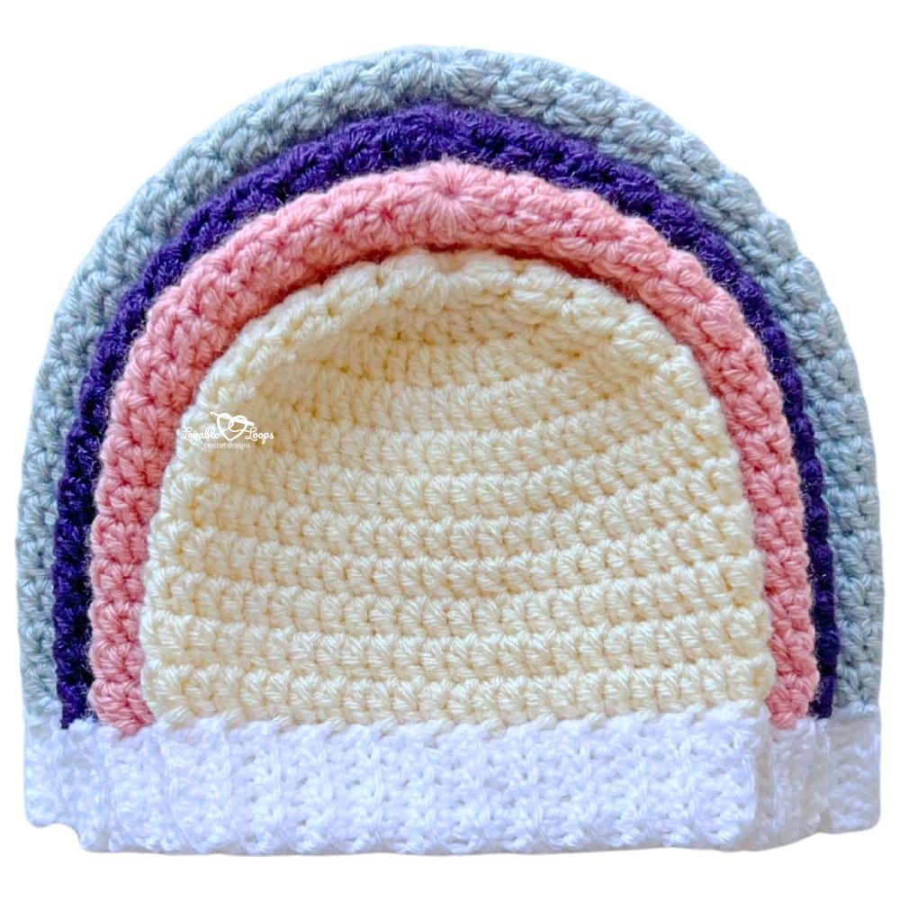 How to crochet a beanie in four sizes—finished crochet hats stacked to show baby, toddler, child, and adult sizing.