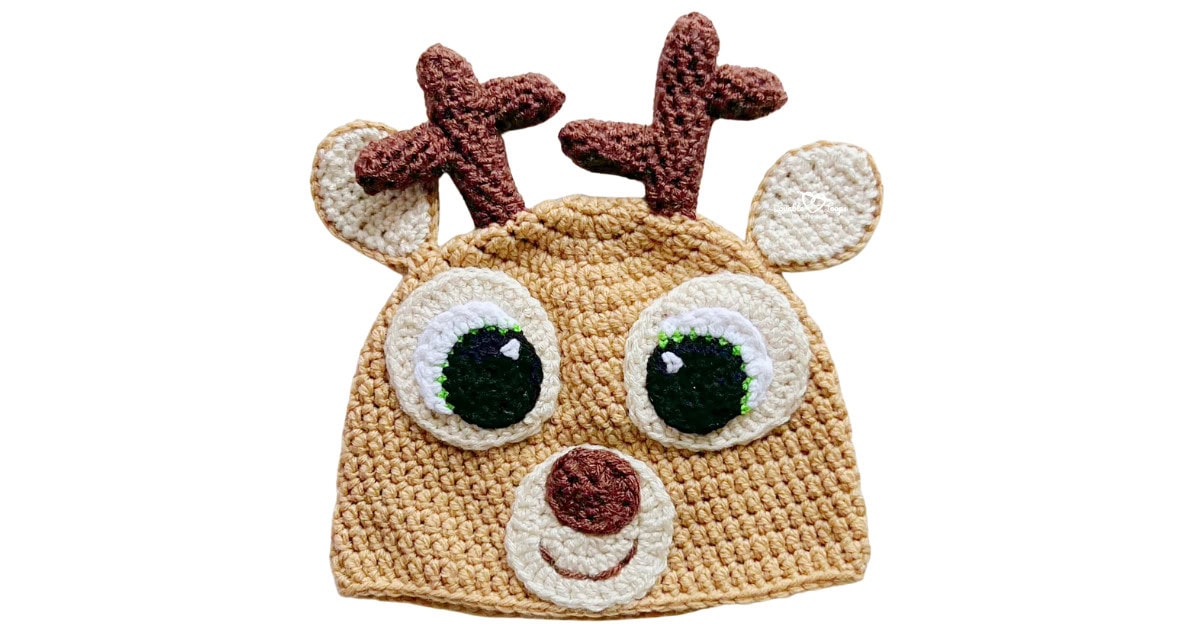 Finished crochet deer hat with brown antlers, cream ears, large eyes, and a cream muzzle, shown on a light background.