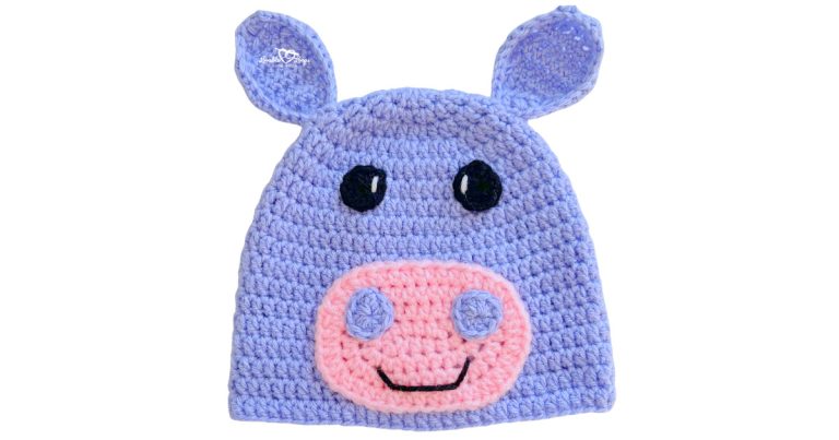 Light purple crochet hippo hat with small ears, black eyes, and a pink snout with nostril details.