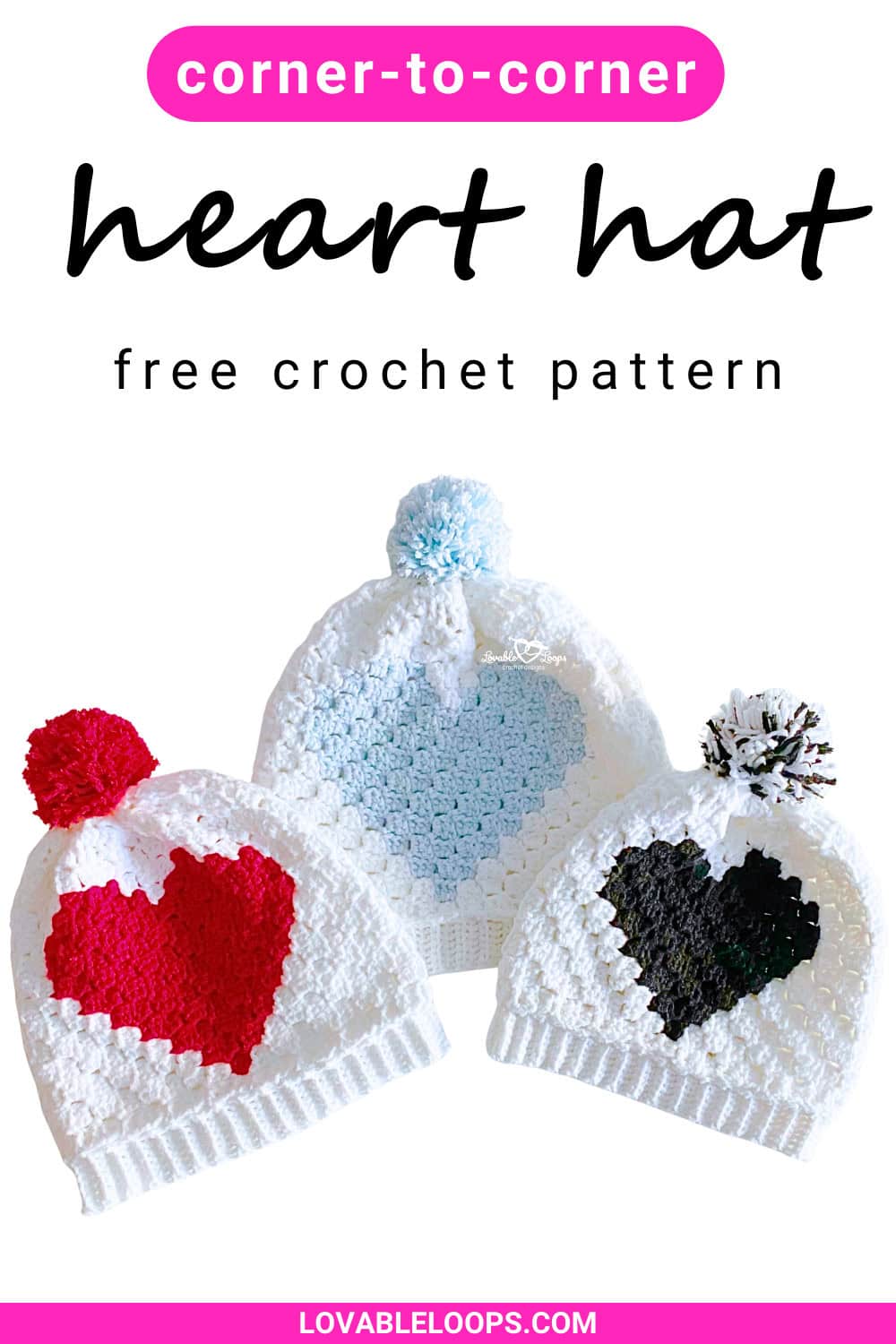 Three heart hats with pom pom and ribbed brims laid laid flat. The hats are white with a red, blue, or black heart on the front.