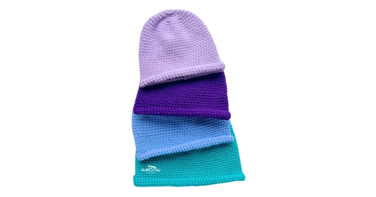 Stacked single crochet beanies in baby, toddler, child, and adult sizes showing the top-down construction and rolled brim