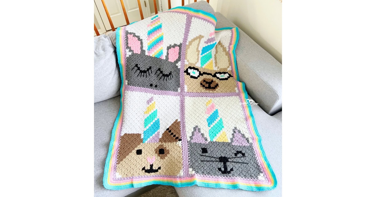 Unicorn animal crochet blanket pattern made with C2C panels, featuring four cute unicorn faces and a rainbow border