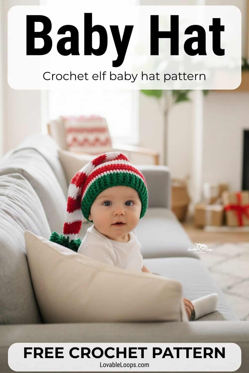 Baby wearing a red, white, and green crochet elf hat while sitting on a couch in a cozy Christmas living room