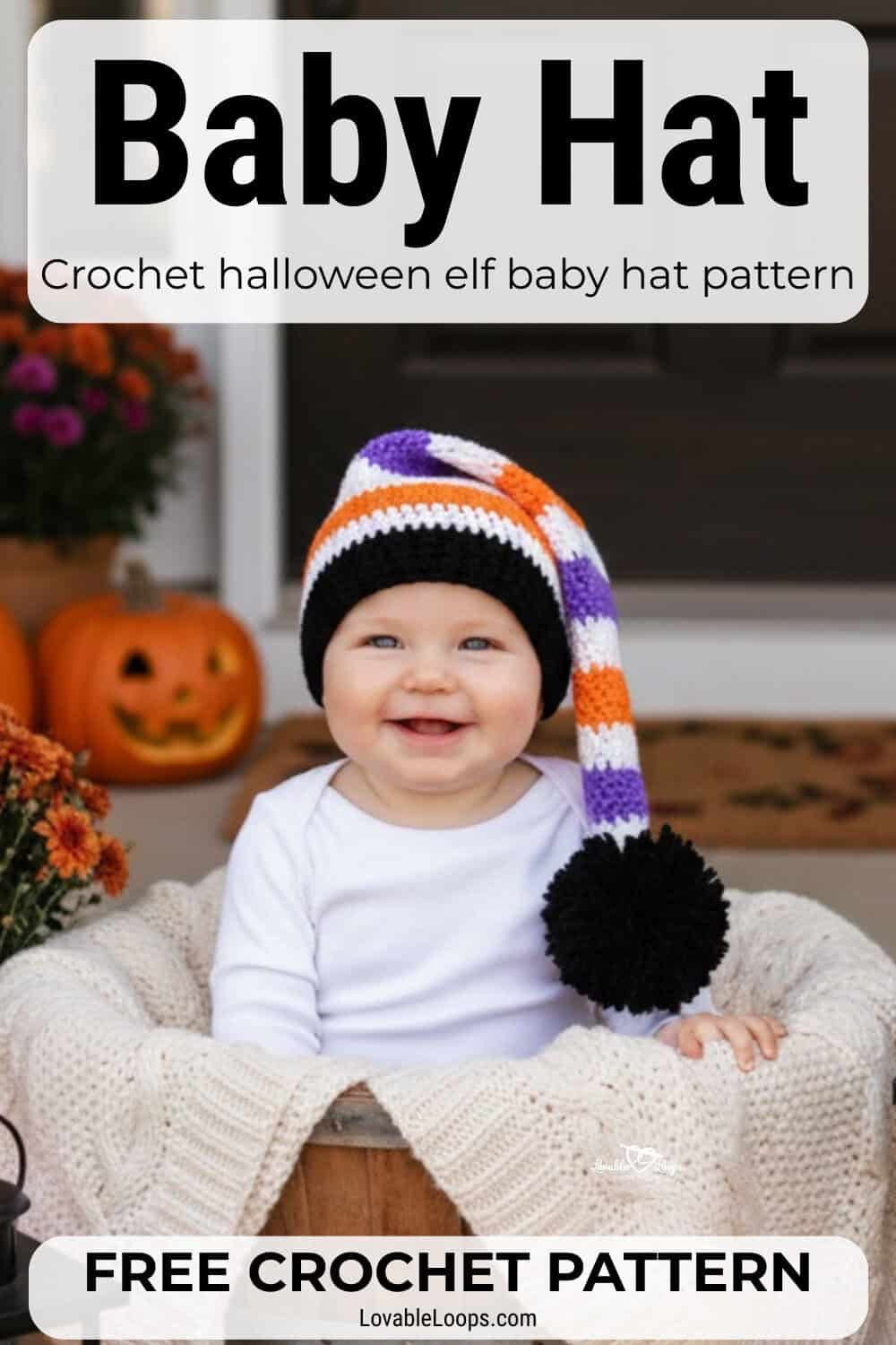 Baby wearing a striped crochet Halloween elf hat in orange, purple, white, and black while sitting in a basket on a porch with pumpkins and fall flowers