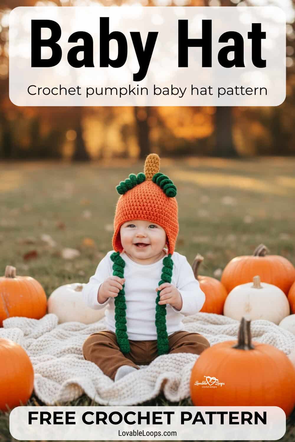 Baby wearing an orange crochet pumpkin hat with a stem top and curly green ties while sitting outdoors with pumpkins on a cozy fall blanket