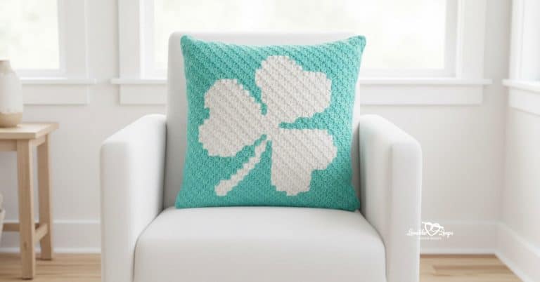Aqua crochet shamrock pillow on a white armchair with soft natural light.