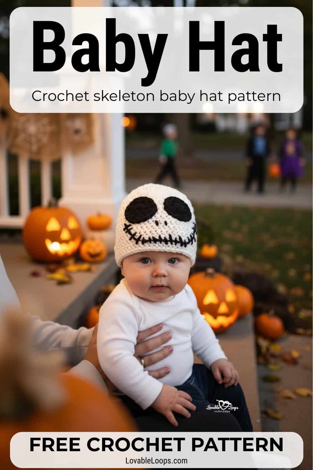 Baby wearing a white crochet skeleton hat with black face details while sitting outside near glowing jack-o’-lanterns at Halloween