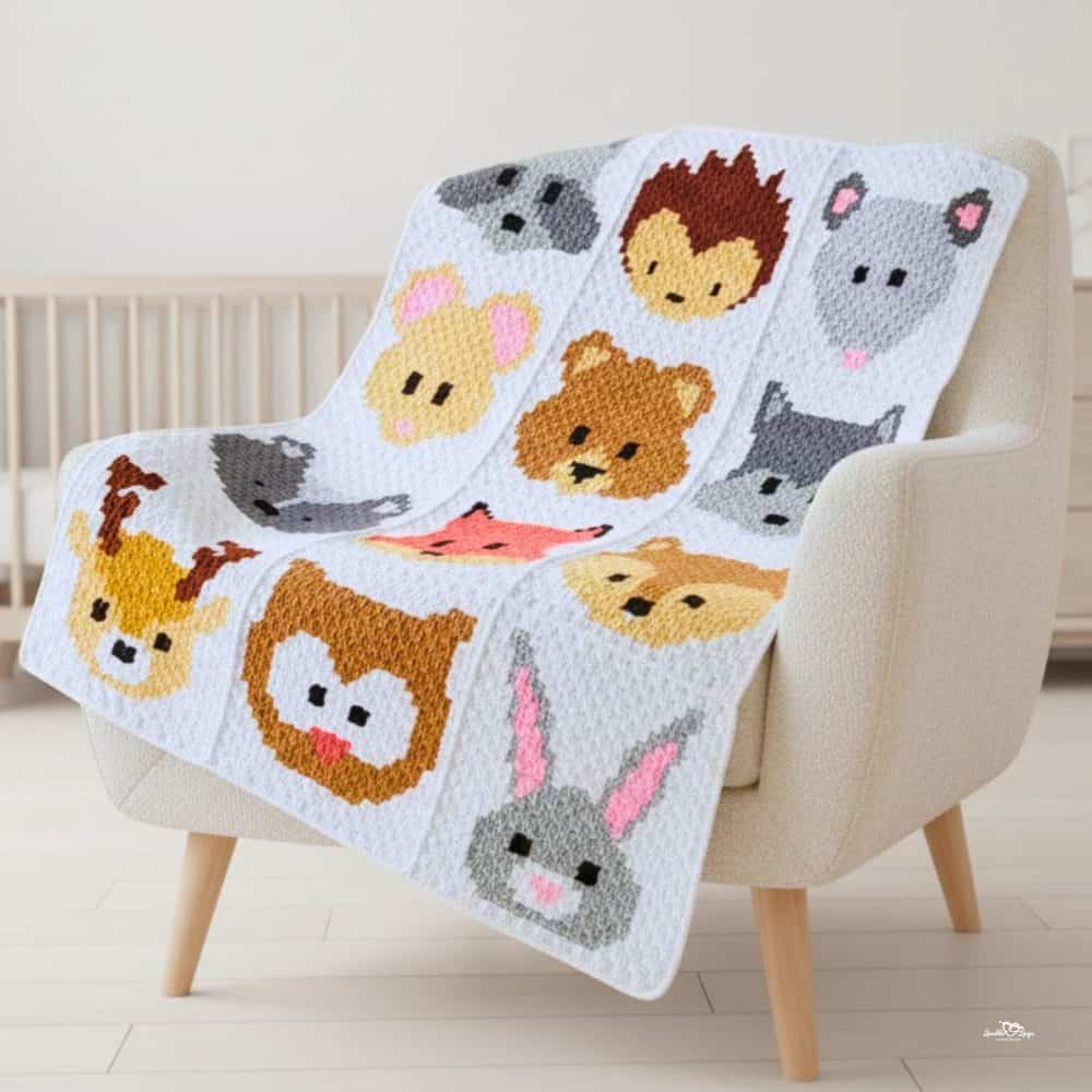 C2C woodland animal crochet blanket draped over a cream armchair, featuring cute forest animal faces in multiple blocks.