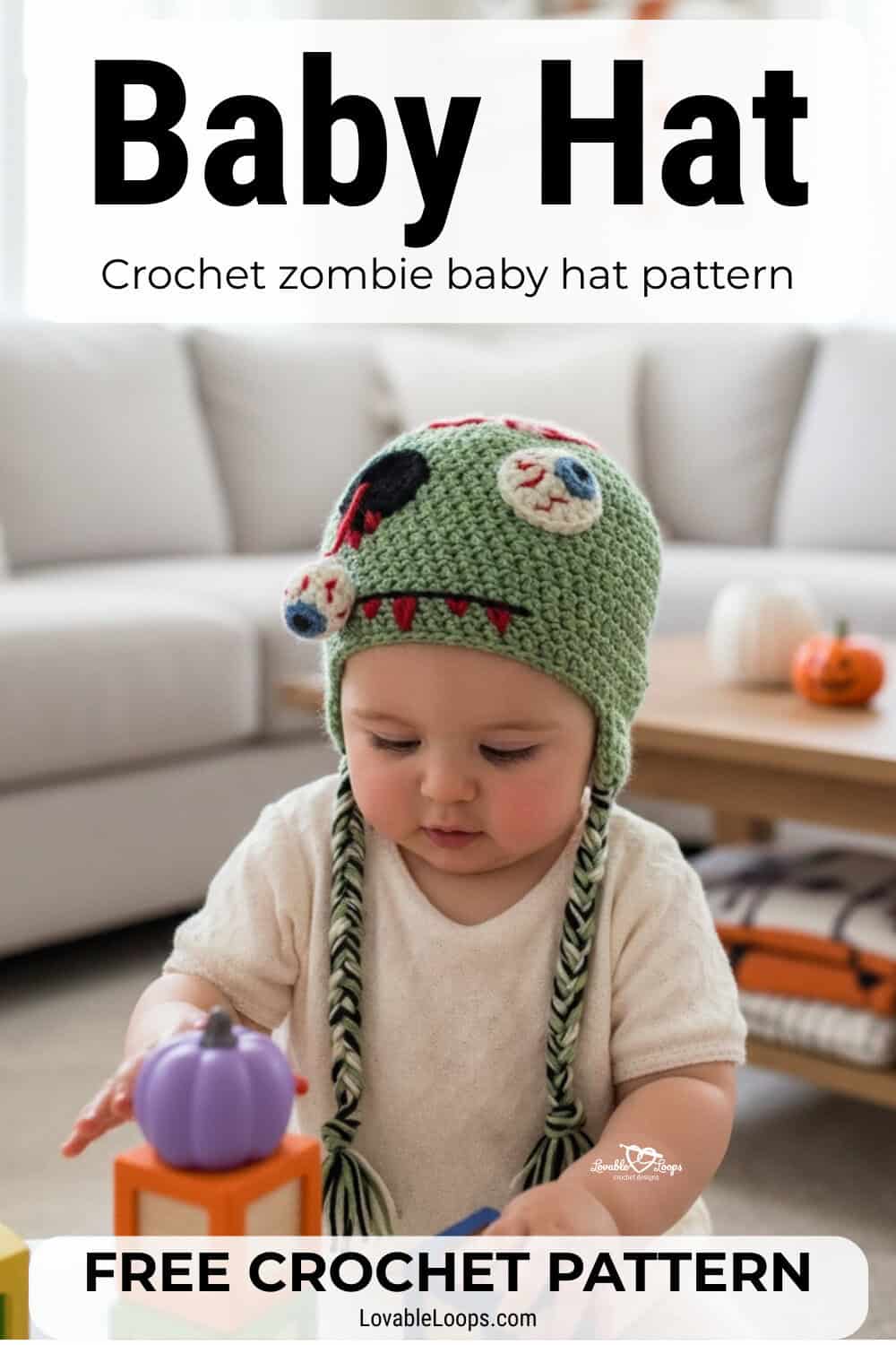 Baby wearing a green crochet zombie hat with spooky face details and braided earflaps while playing with blocks in a cozy living room with subtle Halloween decor