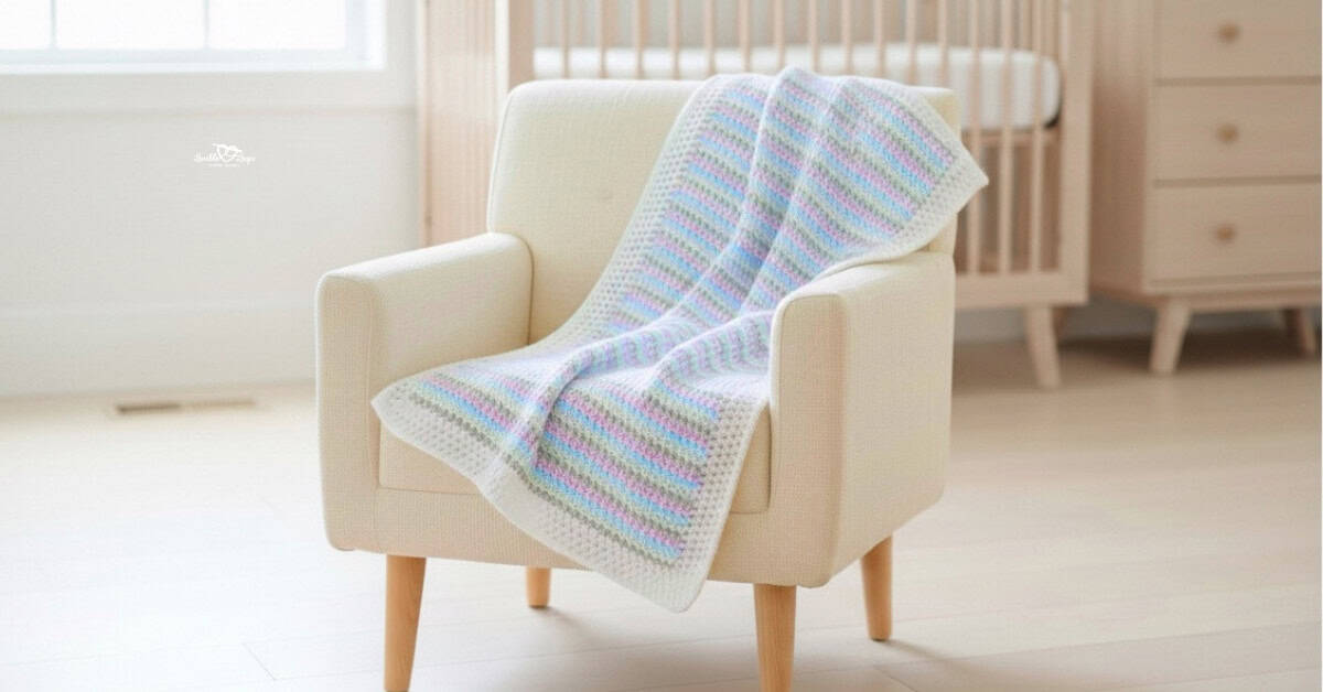 Pastel striped crochet baby blanket with a white border draped over a cream armchair in a bright nursery.