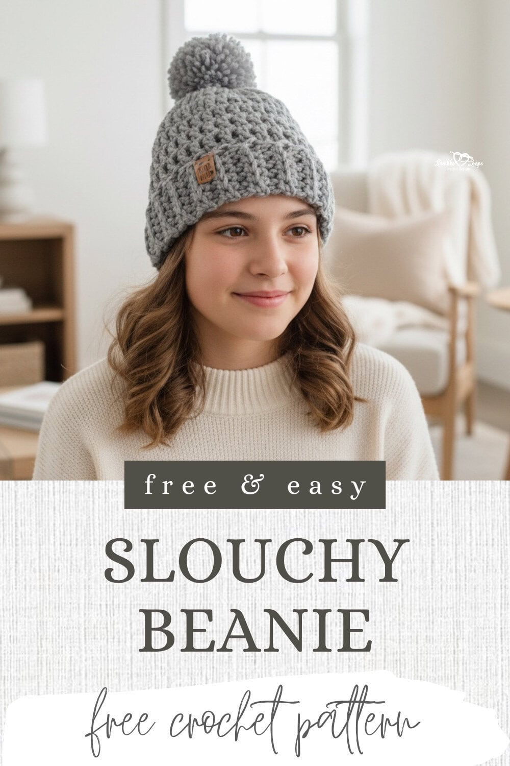 Free and easy slouchy beanie free crochet pattern Pinterest pin with bold text and a model wearing a gray crochet pom pom beanie in a soft neutral living space.