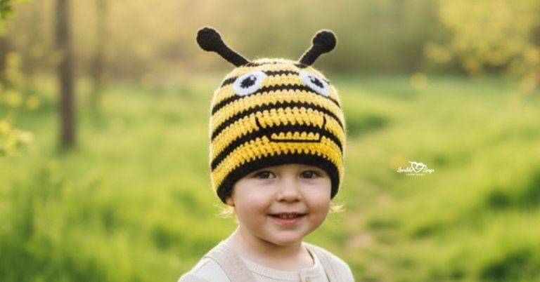 Child wearing a yellow and black crochet bee hat on a bright green nature trail with soft trees in the background
