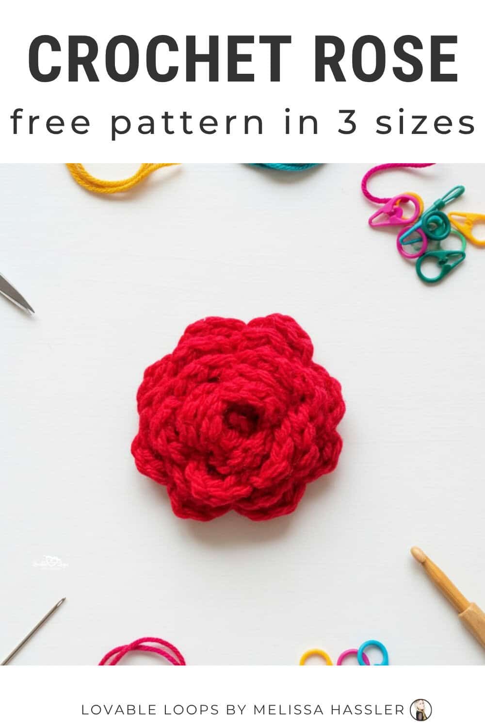 Crochet rose pattern displayed on a bright white desktop with a red crochet rose and simple craft tools around it.