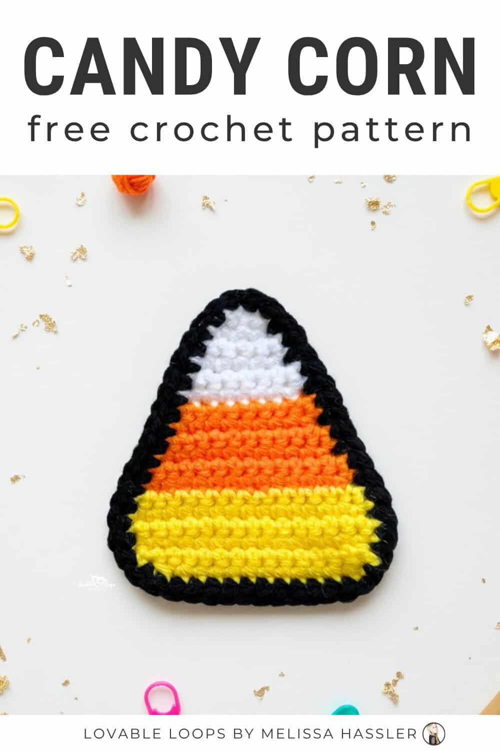 Candy corn crochet pattern displayed on a bright white desktop with a colorful crochet candy corn applique and simple craft tools around it.