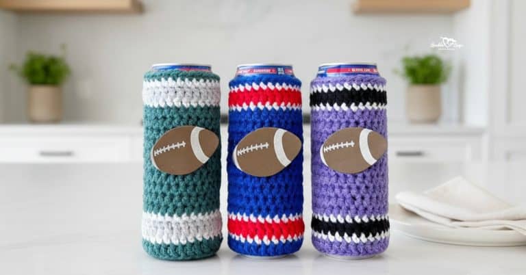 Three crochet football can koozies on a white kitchen island in teal, blue, and purple striped colorways, each with a football applique on the front.