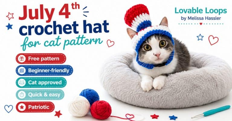 Gray and white cat wearing a red, white, and blue crochet hat while resting on a soft gray cat bed.