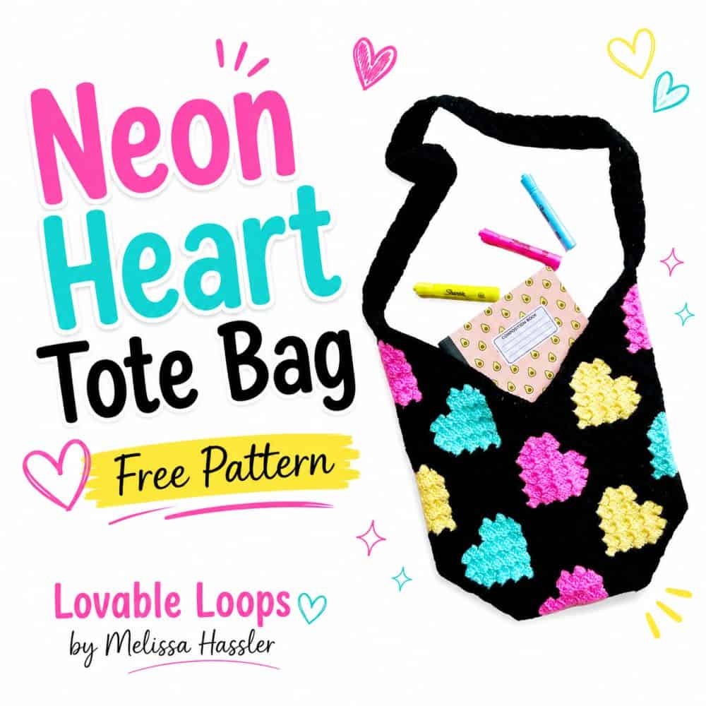 Free crochet neon hearts bag pattern featuring a black C2C tote with bright colorful heart motifs, a black strap, and a notebook with markers peeking from the top.